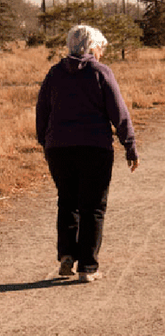 woman walking on a dusty road